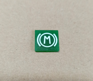 Symbol překlápěcího přepínače - 14x14mm - zelený - motorová brzda "M"